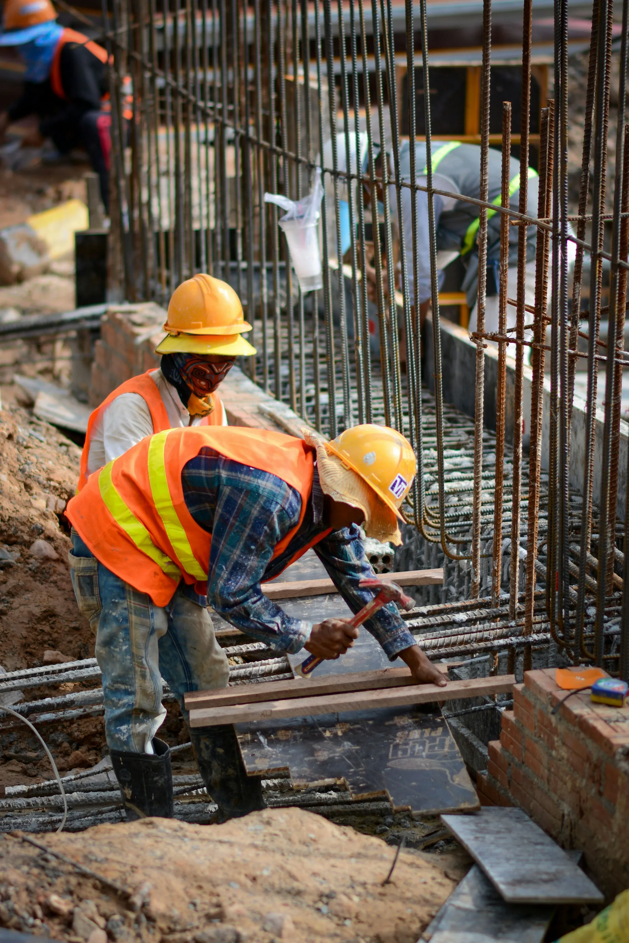 Workers in hard hats and hi-vis vests on a job site